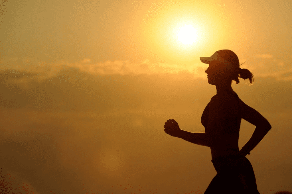 Woman running at sunrise to reduce stress