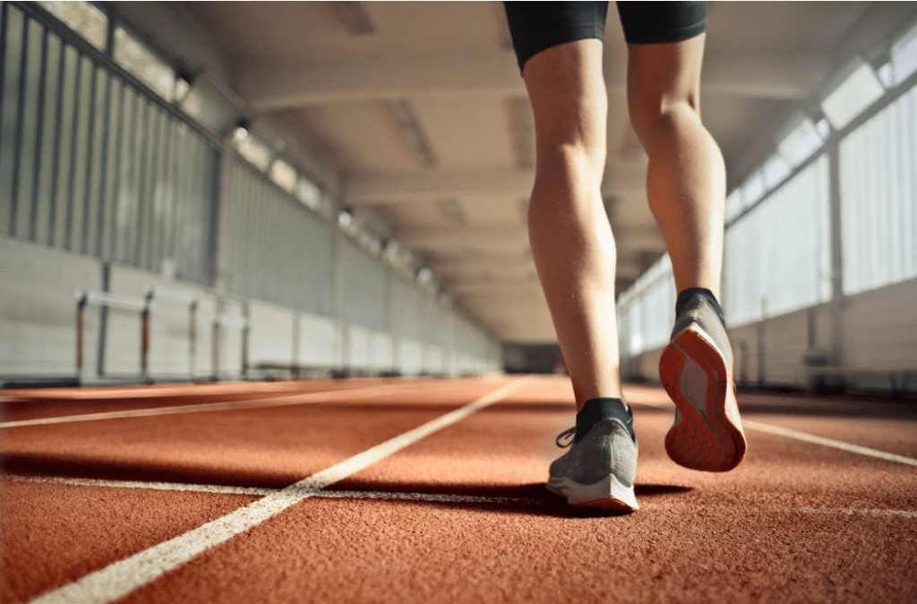 Woman doing steady-state cardio jogging on a track