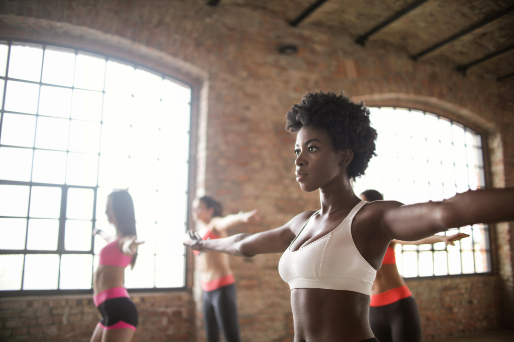 Four woman engaging in a workout in the gym to see benefits