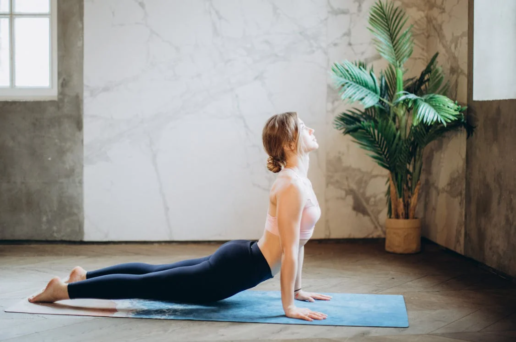 Women doing yoga poses on a yoga mat to improve mental benefits