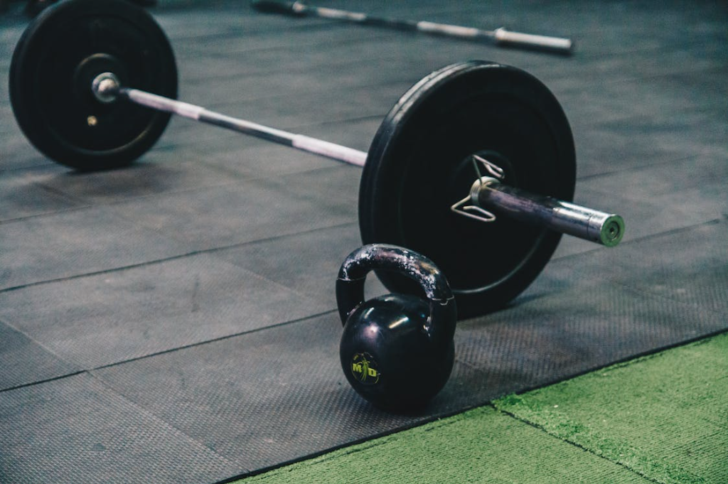 Barbell and kettlebell loaded with weight in the gym