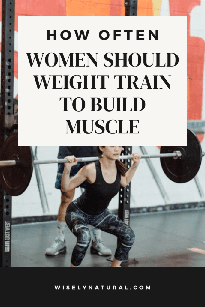 Woman squatting in the gym with a spotter