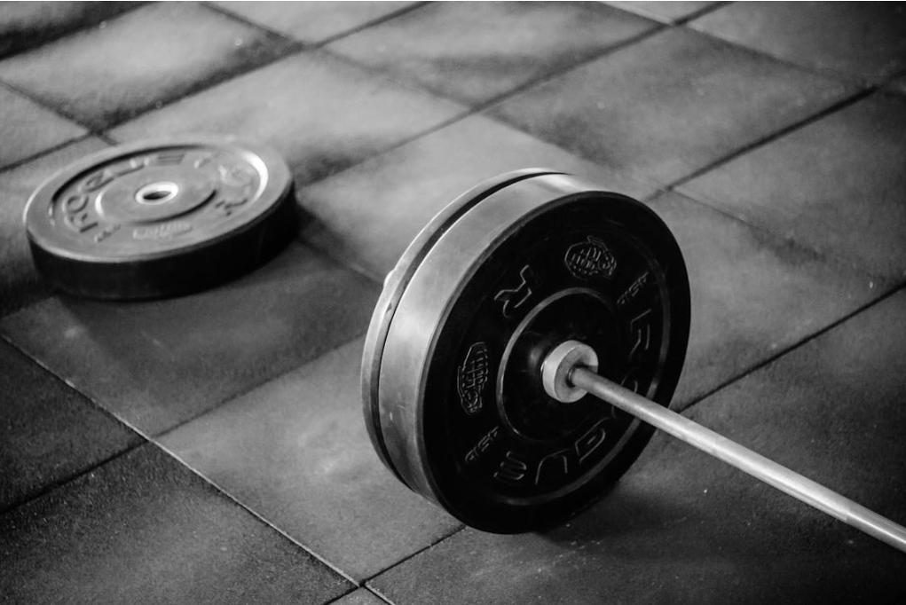 Heavy barbell and weights on the gym floor
