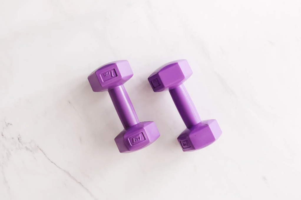 Two dumbells on the gym floor.